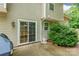 This patio features sliding glass doors and a small bush next to the house at 7206 Stoney Place Ct, Charlotte, NC 28262