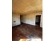View of living room, needing renovations, featuring hard wood floors at 722 S Weldon St, Gastonia, NC 28052