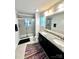 Modern bathroom featuring double sinks, granite countertops, and a sleek glass shower enclosure at 7416 Hartsfield Dr, Lancaster, SC 29720
