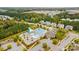 Aerial view of community pool area with a splashpad, covered tables, and mature trees for a lush backdrop at 7416 Hartsfield Dr, Lancaster, SC 29720