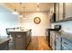 An open kitchen features granite countertops, stainless steel appliances, and gray cabinets at 7416 Hartsfield Dr, Lancaster, SC 29720