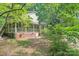 Lovely home with brick foundation and wraparound porch, surrounded by trees at 8504 Knollwood Cir, Charlotte, NC 28213