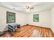 Bright bedroom featuring wood floors, a ceiling fan, and natural light at 8504 Knollwood Cir, Charlotte, NC 28213