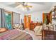 Comfortable bedroom featuring warm lighting, multiple windows, and cozy decor at 8504 Knollwood Cir, Charlotte, NC 28213