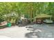 Exterior view of home with large yard, two car driveway, and lush trees surrounding the property at 8504 Knollwood Cir, Charlotte, NC 28213