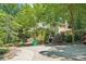 Charming two-story home with lush landscaping and a driveway, plus a brick chimney at 8504 Knollwood Cir, Charlotte, NC 28213