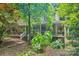 Charming home with a covered front porch and lush landscaping at 8504 Knollwood Cir, Charlotte, NC 28213