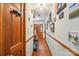 Inviting hallway with wood floors, a light neutral color scheme, and decorative wall art at 8504 Knollwood Cir, Charlotte, NC 28213