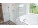 Bright bathroom featuring a soaking tub, glass enclosed shower, and a window with nature views at 8692 Acadia Pkwy # 591, Sherrills Ford, NC 28673