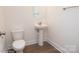 Bright powder room features a round mirror, pedestal sink, and wood-look flooring at 8692 Acadia Pkwy # 591, Sherrills Ford, NC 28673
