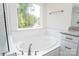 Bright bathroom featuring a soaking tub, granite counters, subway tiles, and a window with nature view at 8692 Acadia Pkwy # 591, Sherrills Ford, NC 28673