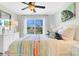 Bright bedroom with a colorful bedspread, a large window with views, and ceiling fan at 8692 Acadia Pkwy # 591, Sherrills Ford, NC 28673