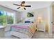 Charming bedroom with a colorful bedspread, large window, and ceiling fan at 8692 Acadia Pkwy # 591, Sherrills Ford, NC 28673