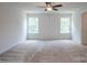Bright bedroom with large windows and neutral carpeting and a ceiling fan at 8692 Acadia Pkwy # 591, Sherrills Ford, NC 28673