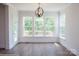 Bright dining area with large windows, wood floors, stylish lighting, and access to the deck at 8692 Acadia Pkwy # 591, Sherrills Ford, NC 28673