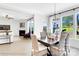 An elegant dining room featuring large windows, a stylish light fixture, and beautiful open access to the living room at 8692 Acadia Pkwy # 591, Sherrills Ford, NC 28673