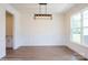 Spacious dining room features an attractive light fixture, wainscoting and large windows for natural light at 8692 Acadia Pkwy # 591, Sherrills Ford, NC 28673