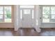 Foyer with lots of natural light, hardwood floors, trim, and a front door with stone accents at 8692 Acadia Pkwy # 591, Sherrills Ford, NC 28673