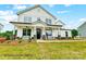 Inviting two-story home with a charming front porch, stone accents, and manicured lawn at 8692 Acadia Pkwy # 591, Sherrills Ford, NC 28673