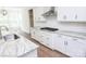 New kitchen featuring granite counters, subway tile backsplash, stainless steel hood, and hardwood floors at 8692 Acadia Pkwy # 591, Sherrills Ford, NC 28673