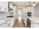 New kitchen featuring granite counters, subway tile backsplash, stainless steel hood, and hardwood floors at 8692 Acadia Pkwy # 591, Sherrills Ford, NC 28673