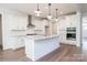 New kitchen featuring granite counters, subway tile backsplash, stainless steel hood, and hardwood floors at 8692 Acadia Pkwy # 591, Sherrills Ford, NC 28673