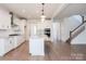 Spacious kitchen featuring stainless appliances, granite countertops, island and white cabinetry at 8692 Acadia Pkwy # 591, Sherrills Ford, NC 28673