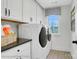 Well-organized laundry room with washer, dryer, cabinets and view to the outdoors at 8692 Acadia Pkwy # 591, Sherrills Ford, NC 28673
