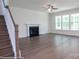 Open living room featuring hardwood floors, a fireplace, large windows, and stairway at 8692 Acadia Pkwy # 591, Sherrills Ford, NC 28673