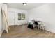 Bright bedroom featuring stylish wood flooring, a closet, and a modern desk setup for work at 875 Marys Grove Rd, Cherryville, NC 28021