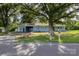 Charming blue single story home with mature trees and a welcoming front yard at 875 Marys Grove Rd, Cherryville, NC 28021