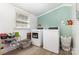 Bright laundry room with modern washer and dryer, window, and wood-look floors at 875 Marys Grove Rd, Cherryville, NC 28021