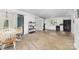 Open layout combines a dining area with a kitchen featuring white cabinets and black appliances at 875 Marys Grove Rd, Cherryville, NC 28021
