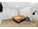 Bright main bedroom featuring carpet floors, neutral walls, and natural light at 875 Marys Grove Rd, Cherryville, NC 28021