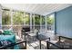 Enclosed sunroom with views of the greenery, seating, and lattice railing at 875 Marys Grove Rd, Cherryville, NC 28021