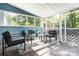 Light-filled sunroom with comfortable seating, views of the backyard trees and sky at 875 Marys Grove Rd, Cherryville, NC 28021