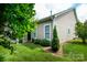 Beautiful backyard with a manicured lawn, lush greenery, and mature trees at 8818 Artesa Mill Ln, Charlotte, NC 28214