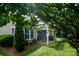 Charming home exterior with a covered patio and beautiful landscaping at 8818 Artesa Mill Ln, Charlotte, NC 28214