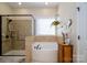 Relaxing bathroom featuring a soaking tub and a separate glass-enclosed shower at 8818 Artesa Mill Ln, Charlotte, NC 28214