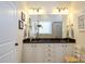 Bathroom with a double sink vanity, large mirror, and plenty of storage space at 8818 Artesa Mill Ln, Charlotte, NC 28214