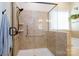 Bright bathroom featuring a glass-enclosed shower with tiled walls and a handheld shower head at 8818 Artesa Mill Ln, Charlotte, NC 28214
