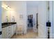 Bathroom featuring tiled floors, a vanity with drawers and doors, and a walk-in closet at 8818 Artesa Mill Ln, Charlotte, NC 28214