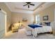 Comfortable bedroom with a tray ceiling, ceiling fan, large window, and neutral decor at 8818 Artesa Mill Ln, Charlotte, NC 28214