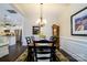 Formal dining room with hardwood floors, a chandelier, and a view into the kitchen at 8818 Artesa Mill Ln, Charlotte, NC 28214