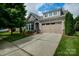 Charming home with a two-car garage, manicured lawn, and beautifully landscaped front yard at 8818 Artesa Mill Ln, Charlotte, NC 28214