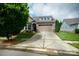 Inviting home featuring a two-car garage, well-maintained lawn, and charming facade at 8818 Artesa Mill Ln, Charlotte, NC 28214