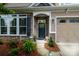 Inviting front entrance with stone accents, elegant door, and beautifully landscaped surroundings at 8818 Artesa Mill Ln, Charlotte, NC 28214