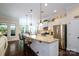 Modern kitchen with white cabinets, stainless steel appliances, and a large center island with seating at 8818 Artesa Mill Ln, Charlotte, NC 28214