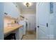 Convenient laundry room featuring a washer, dryer, storage cabinets, and a countertop folding area at 8818 Artesa Mill Ln, Charlotte, NC 28214