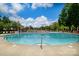 Large, inviting community pool with lounge chairs and a view of the pool house at 8818 Artesa Mill Ln, Charlotte, NC 28214